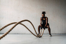 Image Of African American Sportsman Working Out With Battle Ropes