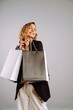 © maxbelchenko - Portrait of nice charming woman with shopping bags. Sale, fashion, black friday and luxury concept.