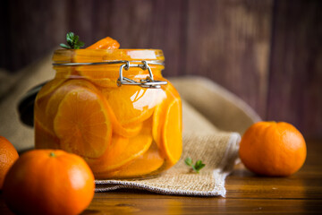 Canvas Print - tangerine jam in a glass jar on a wooden table