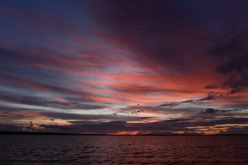 Wall Mural - sky colors at sunset over cold water