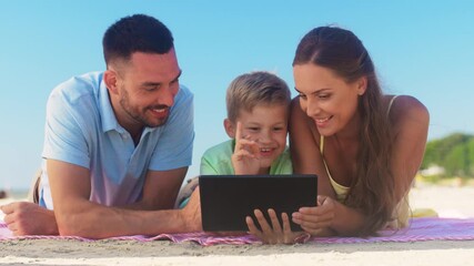 Poster - family, leisure and people concept - happy mother, father and son with tablet computer laying on summer beach