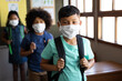 © Wavebreak Media - Group of kids wearing face masks with bag packs standing in a queue at school