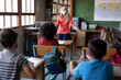 © Wavebreak Media - Female teacher wearing face mask teaching in class at school