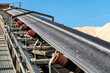 © Michal - Close-up shot of the conveyor belt in the concrete plant with transport rollers, visible metal stairs.