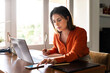 © VITTA GALLERY/Westend61 - Businesswoman using smart phone while working at home