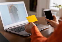 Cropped Image Of Businesswoman With Credit Card Using Smart Phone While Purchasing Online At Home