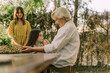 © Eloisa Ramos/Westend61 - Woman looking at senior woman playing with cute granddaughter in yard