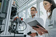 © Mareen Fischinger/Westend61 - Male and female scientists examining machinery in laboratory