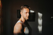 © Miguel Frias/Westend61 - Sunlight falling on serious mid adult man face standing at home