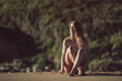 © Mikel Taboada/Westend61 - Thoughtful young woman in bikini sitting at beach during sunset