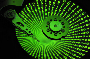 Wall Mural - closeup of computer open hard disk drive with binary code effect reflected