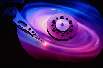 Wall Mural - closeup of computer open hard disk drive with colored abstract effect reflected