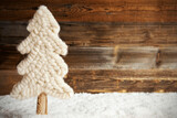 Fototapeta Mapy - Fabric White Christmas Tree With Snow. Brown Rustic Wooden Background. Copy Space For Advertisement