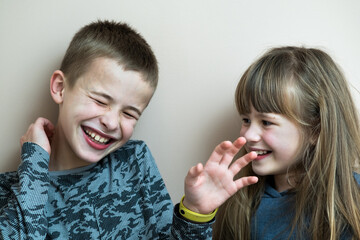 Wall Mural - Two children boy and girl fooling around having fun together. Happy childhood concept.