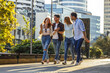 © BalanceFormCreative - Group of young people hangout at the city street. They walk together and making fun.