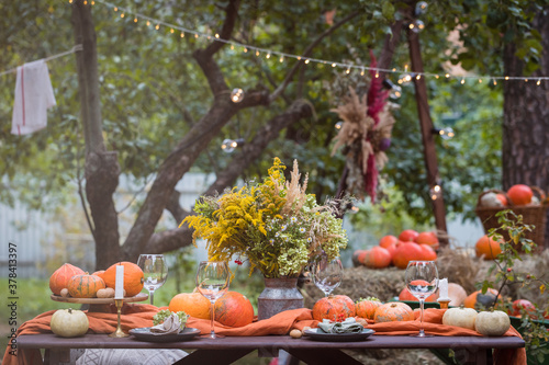 Fall themed holiday table setting arrangement for a seasonal party