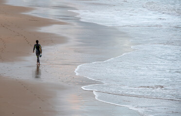 young surfer prepared to enter the water