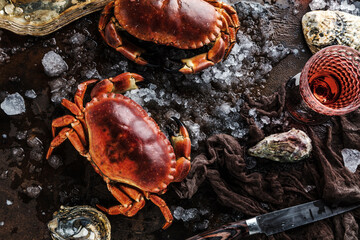 close-up view of gourmet crabs and oysters with ice on grey surface 