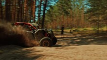 SLOW MOTION: Buggy Car Driving Fast In Cross Country Road. Fast Rally Auto Is Going With Big Clouds Of Dust. Speed Riding Of A Racing Off-road Car In The Forest Road. Cinematic Sport Clip.