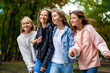 © Andrey_Arkusha - Four teenagers girls walking in autumn park