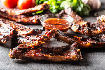 Wall Mural - Baked glazed bbq ribs with a chilli sauce on the side