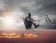 © alphaspirit - Businessman runs fast driving a cart on fire during a competition