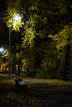 Autumn Park At Night With Lighted Lanterns And Empty Benches