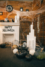 Vertical. Photo Of Halloween Decorations In A Cozy Room With A Fireplace And An Armchair. Background. Decorated Area For Halloween.