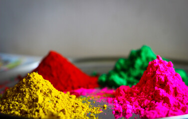 Holi festival multiple colour powder on a plate red green pink yellow