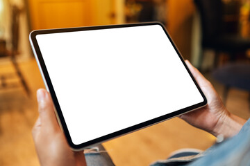 Mockup image of a woman holding digital tablet with blank white desktop screen