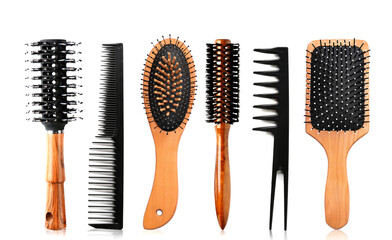 Hair brushes and combs on white background