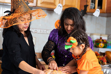 Wall Mural - Family carving a pumpkin in Halloween