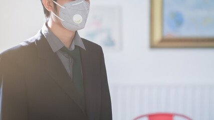 A young businessman wearing a mask to protect the corona virus (COVID-19) that may spread in the air and the mask also protects against small dust or PM 2.5 that is causing problems every year