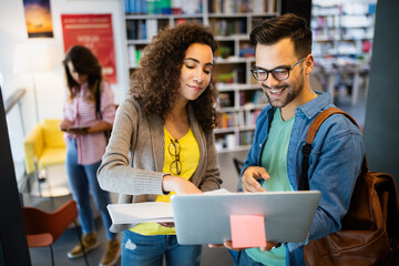 Wall Mural - Group of college students studying in the school library