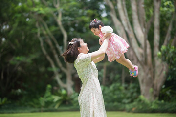 Wall Mural - mother holding cute baby in the garden