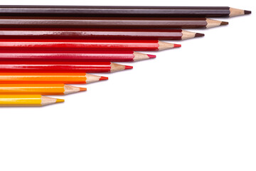 multi-colored wooden pencils in red shades on a white isolated background, autumn colors, mock up, horizontally.