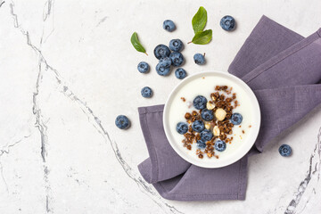 Wall Mural - Healthy breakfast of white yogurt with chocolate granola and blueberry berries