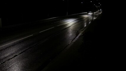 Poster - cars drive along the night road in the city. approaching from afar.
