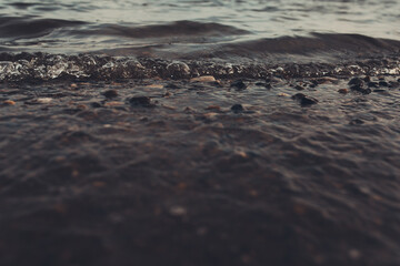 Close-up of water texture, smooth waves of water on the shore, landscape photo of water .  Calm ocean, an incredible element of water