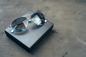 Canvas Print - New dark aviator glasses on grey concrete background