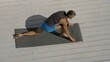 © markwar - Attractive caucasian man doing yoga exercises. Adult handsome bearded man doing fitness on rooftop. Outdoors meditation and wellness lifestyle concept on summer sunny day.
