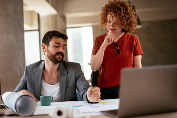 Businessman and businesswoman in office. Businesswoman and businessman working on the project