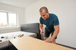 © Xalanx - Man assembling his new furniture
