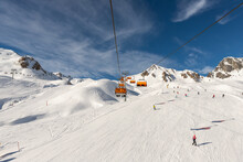 Scenic Panoramic View Of Silvretta Ski Area At Iscgl And Samnaun Skiing Resort With Chairlifts , Downhill Slpoes And Clear Blue Sky On Background. Winter Sport Travel Recreation And Activities