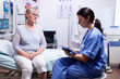 © DC Studio - Nurse writing prescription on clipboard after consultation of elderly woman in hospital examination room. Converstation with medical stuff clinic medicine healthcare.