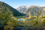 Fototapeta  - Panorama of Tien Shan mountains, Issyk lake and autumn forest. Kazakhstan