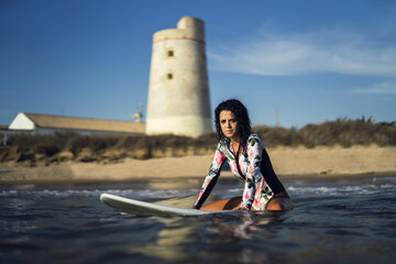 Sticker - View of a European female sitting on a surfboard