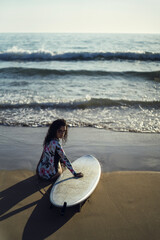 Sticker - vertical shot of a European female posing with her surfboard