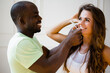© DmitryStock - An African American man touches the girl's face with his hands