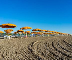 photo of a beach, umbrellas in a row